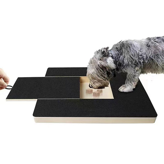 Dog scratching the board to reach treats in the hidden drawer
