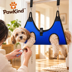 Dog relaxing in the PawKind Calm Grooming Hammock during a nail trim